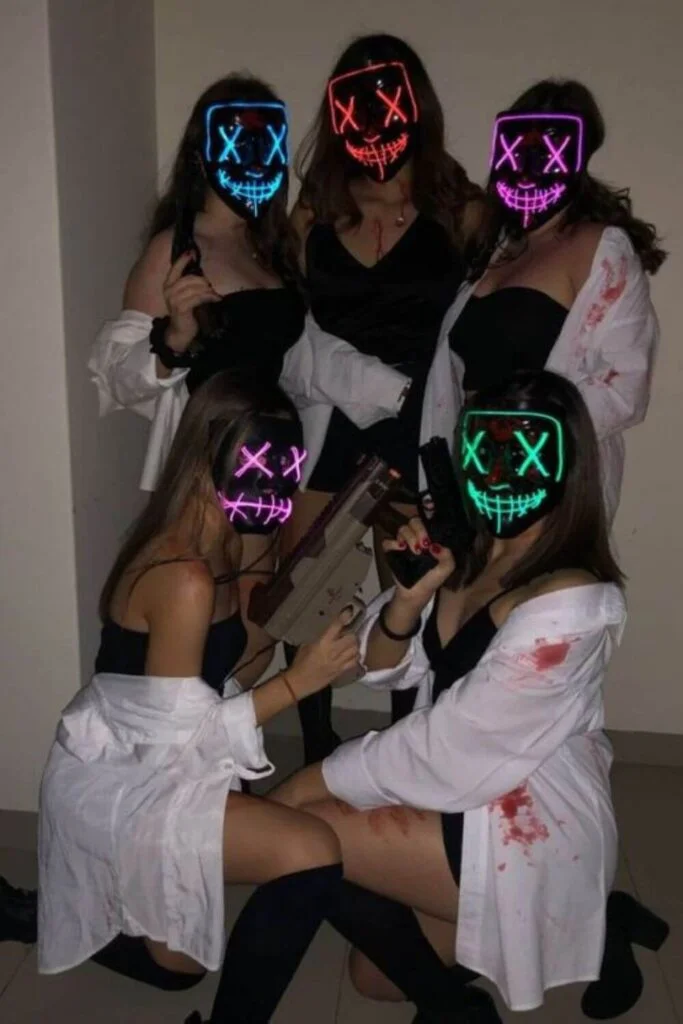 This image is of a group of college friends dressed up as purge characters for halloween. They are wearing black outfits with white pull overs and masks