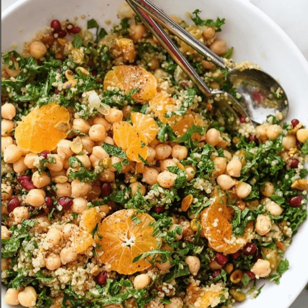 This image is of a high protein quinoa salad with cilantro, oranges, chickpeas and mroe. Great to meal prep for the week in college.