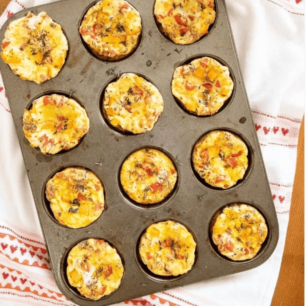This image is of appetizing egg bites with spinach and peppers. Easy to pack up for a snack at college.