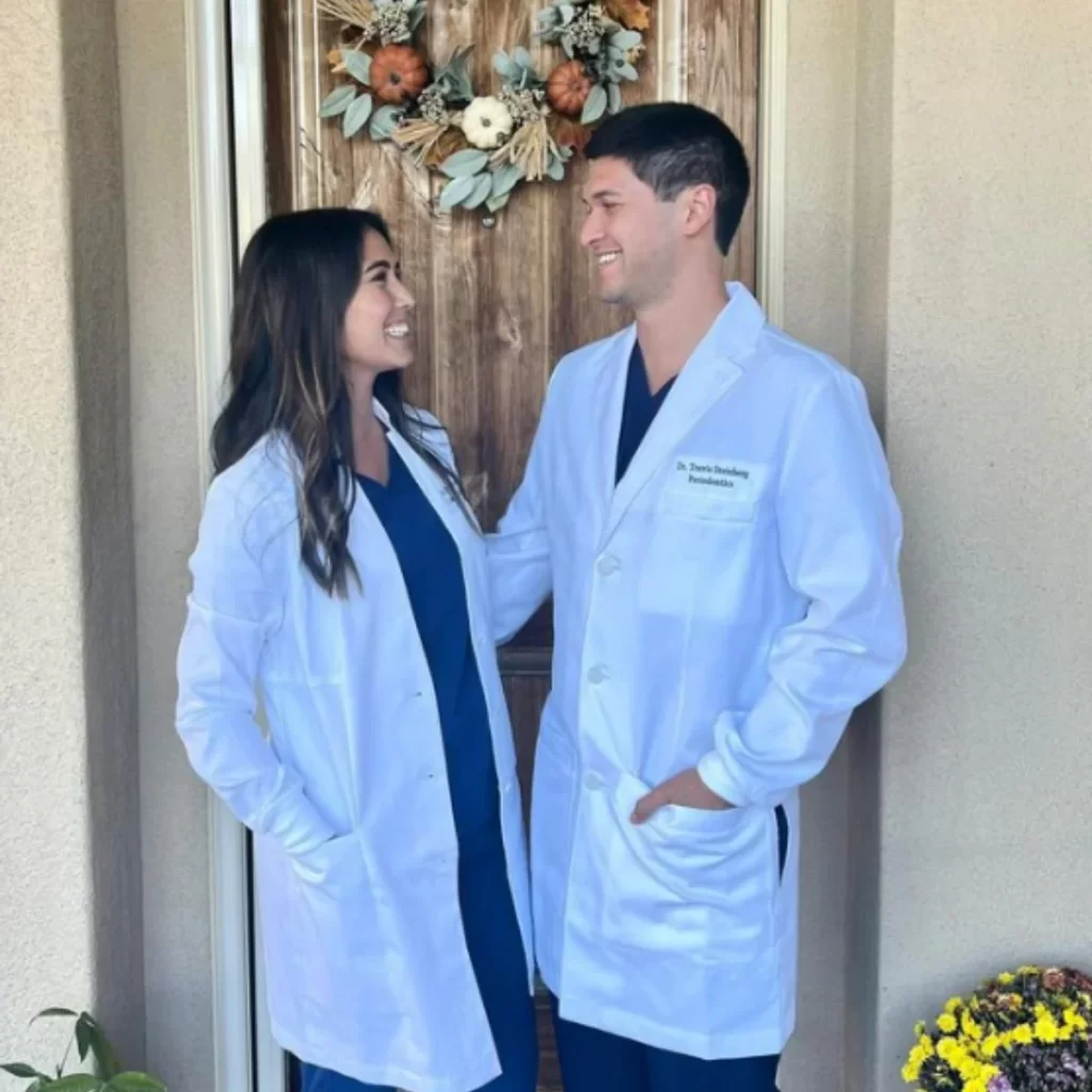 Photo of two professionals standing in a lab coats smiling