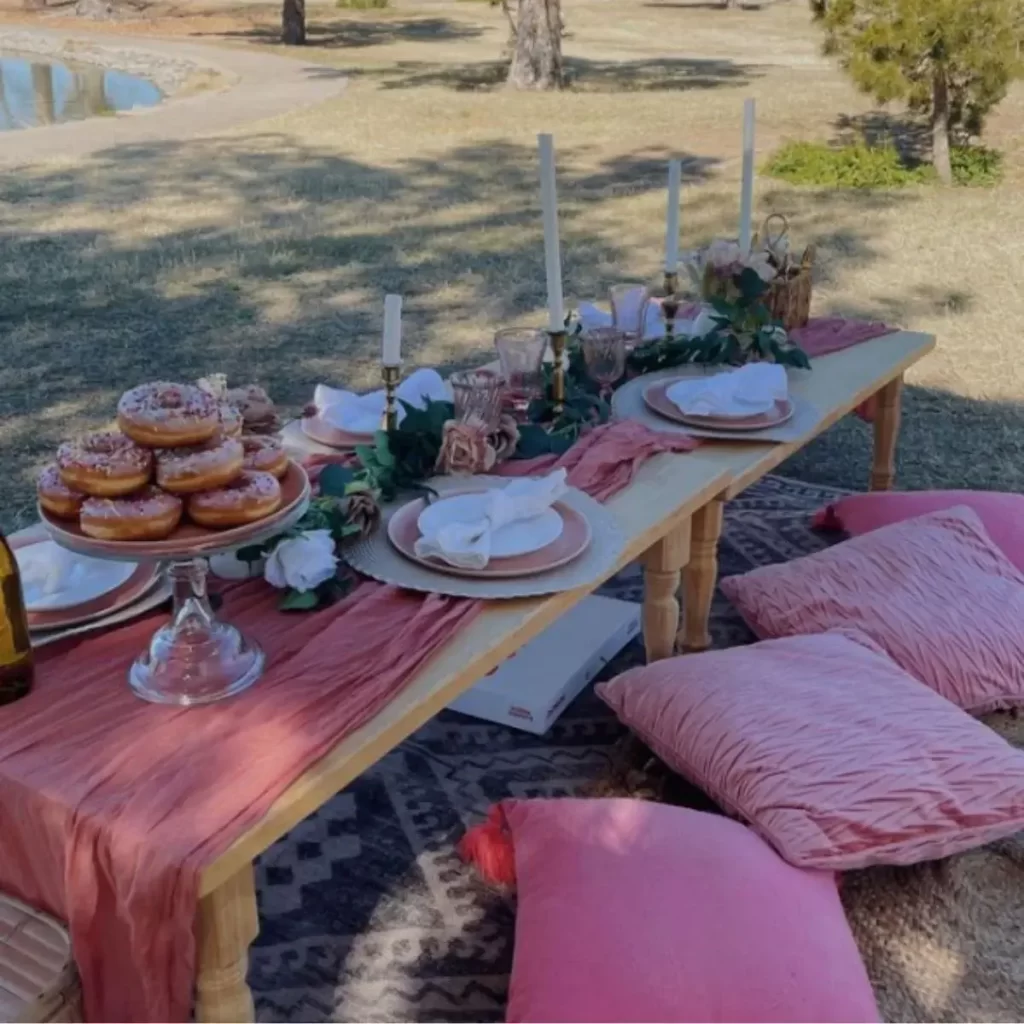 photo of a pink and white picnic setup