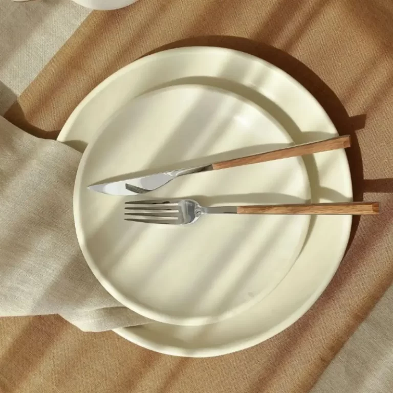 This photo is of two staked ceramic plates with silverware