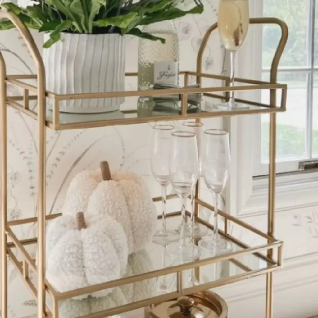 This image is of a bar cart with glass shelves